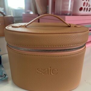 Saie Tan Cosmetic Bag with Silver Zipper and Structured Design